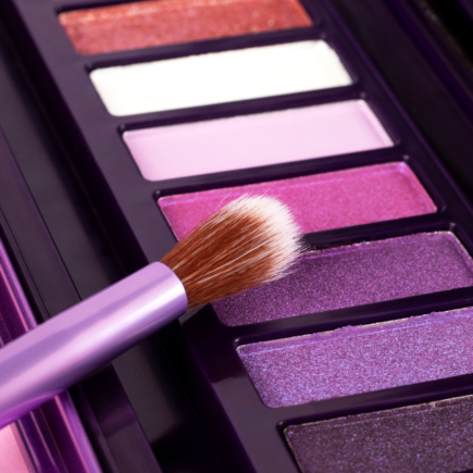 A palette of vibrant pink and purple eyeshadows, which often contain carmine in eye makeup that can trigger allergic reactions.