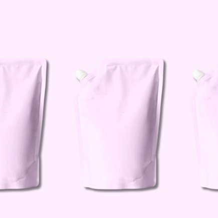 Three identical pink shampoo refill pouches arranged on solid pink background showcasing sustainable hair care packaging
